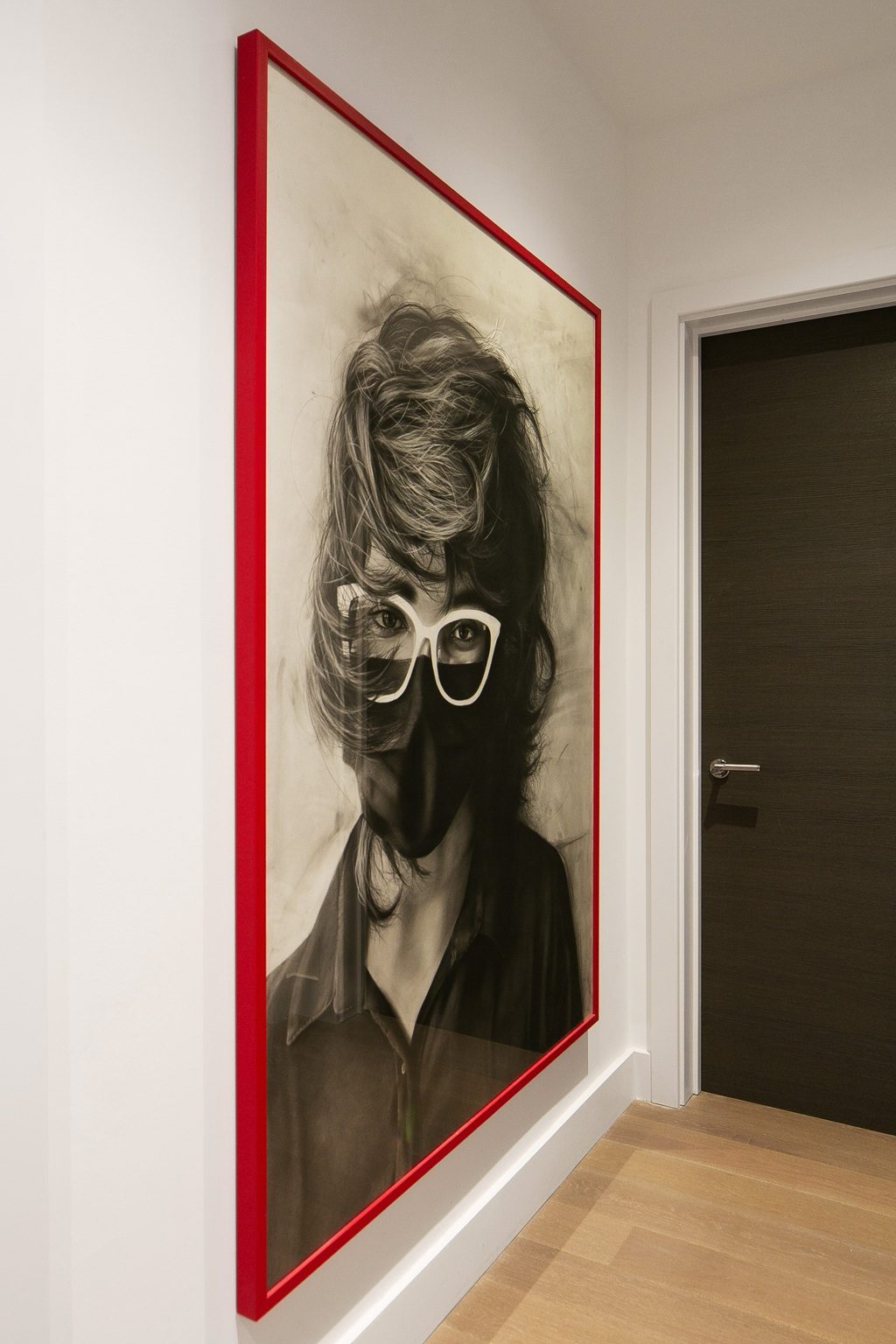 Bedside with brass sconce and stacked stool